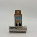 A metallic silver Mable Zero-Waste Dental Floss tube lying horizontally in front of its blue and brown cardboard packaging card, set against a seamless light gray background.
